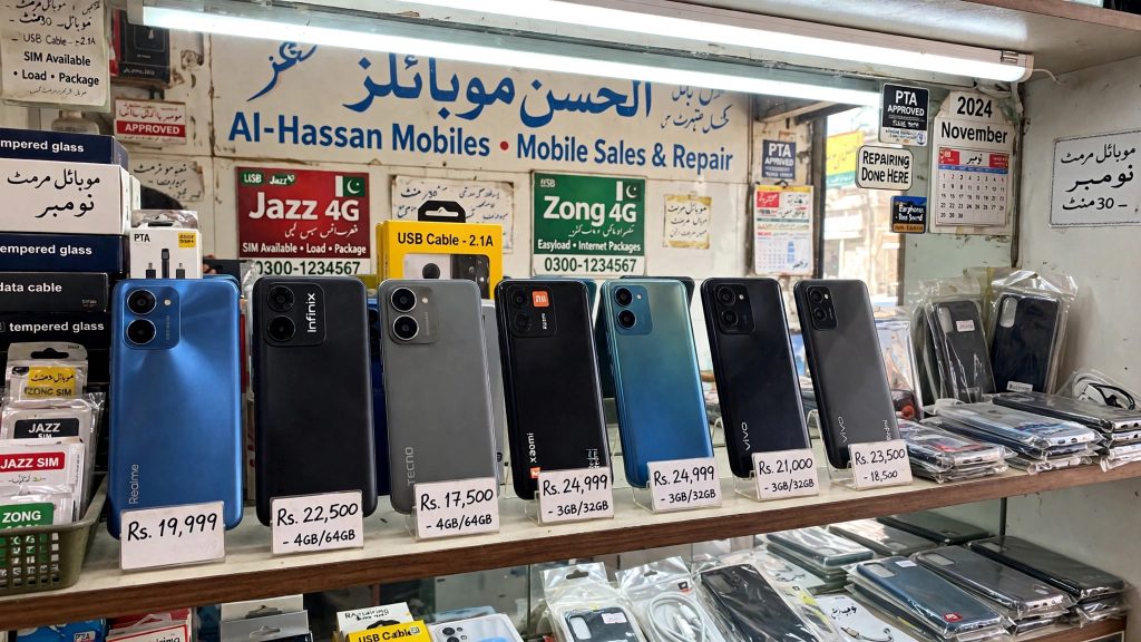Budget smartphones on a shop display shelf in Pakistan
